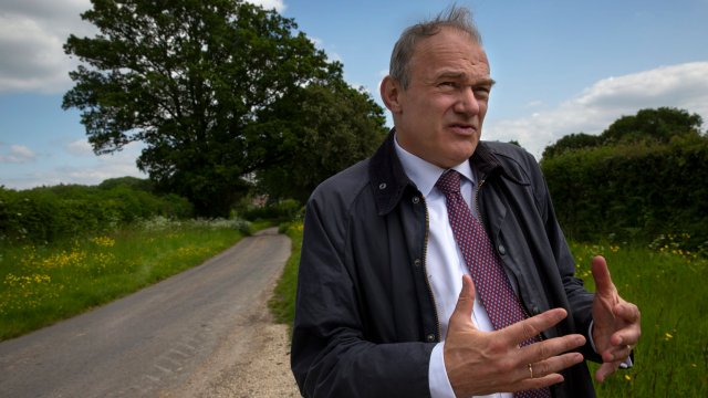 Article thumbnail: Ed Cavey, leader of the Liberal Democrats meets activists and the local candidate Paul Fellows, on a visit to the site of a proposed Gas and oil drill site in Dunsfold, Surrey. 25/5/23. Photo Tom Pilston